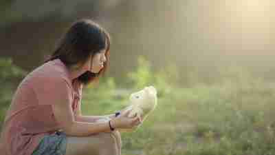 A young girl with anxiety, sitting in a field