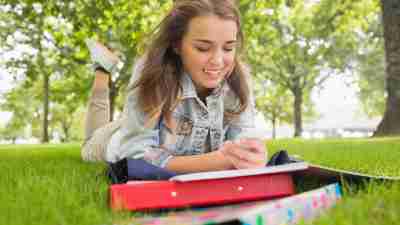 A ADHD girl laying outside trying to help herself focus on homework