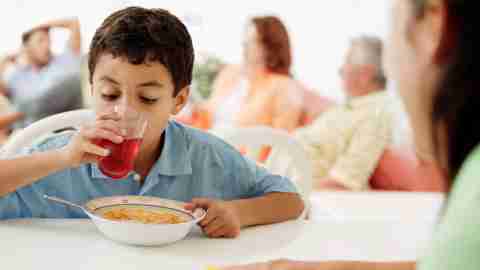 A boy drinks juice with his cereal to boost executive function with sugar