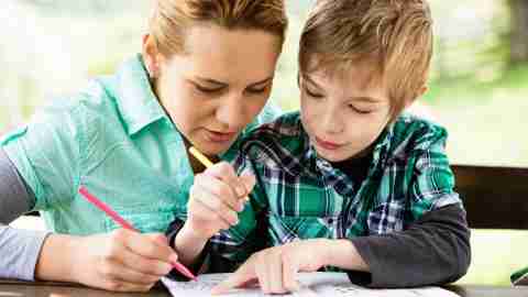 Mother and son working on a coloring book and discussing the side effects of his ADHD medication