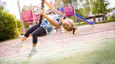 Girl with ADHD on a tire swing is called just a little hyper.