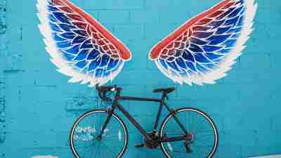 Graffiti of wings over a bicycle to represent autism or learning disabilities