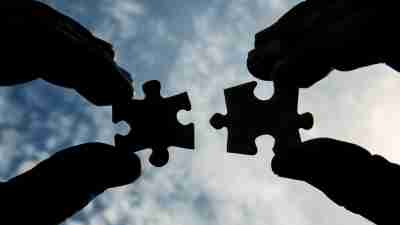 Person holding two puzzle pieces to the sky signifying finding the right specialist for your child with ADHD