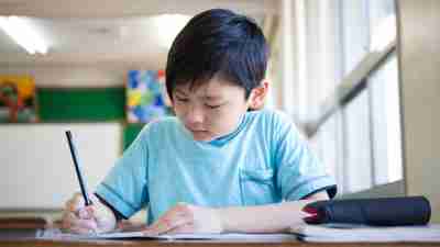 A young boy with ADHD getting organized to study for an upcoming test