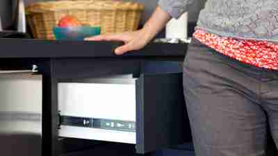 Waist-level view of a person closing an open drawer with their hips.Steve Pomberg / WebMD