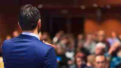 A man at a podium experiencing public speaking anxiety