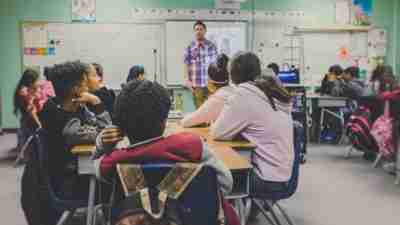 Students in classroom focusing on teacher to demonstrate effective teaching techniques for ADHD students.