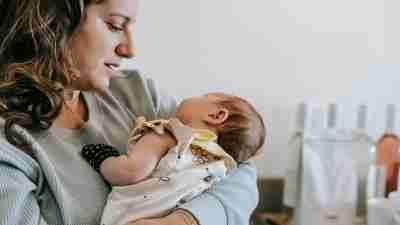 A mother cradling her infant in her arms. Recent studies show that ADHD is a risk factor for postpartum depression.