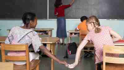 Children with ADHD are easily distracted, not paying attention in school and passing notes instead